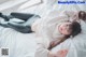 A woman laying on a bed wearing glasses.