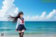 A woman in a school uniform standing on the beach.