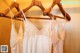 A row of wedding dresses hanging on a wooden hanger.