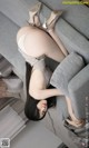 A woman in high heels is sitting on a couch.